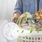 Person sorting clothes in a laundry basket with a close-up of a white showerhead with green leaves.