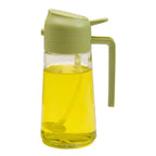 Glass bottle with green lid and handle filled with yellow liquid on a white background